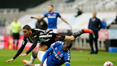 Newcastle's Miguel Almiron is challenged by Everton midfielder Abdoulaye Doucoure. Reuters