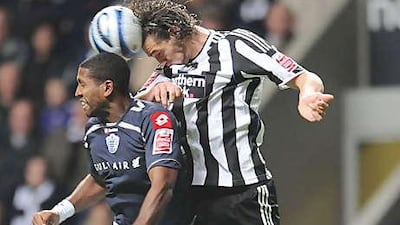 The homegrown striker, Andy Carroll, right, epitomises Newcastle's return to their roots.
