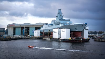 HMS Glasgow is maneuvered on to a barge at the BAE Govan shipyard in Glasgow. PA