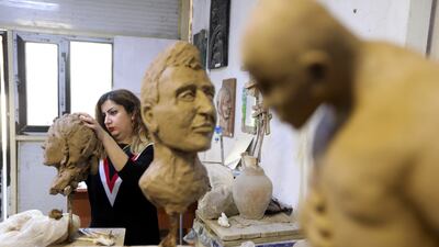 Karmal Mahmood Ali, who teaches sculpture at the College of Fine Arts in Baghdad, takes a class in the Iraqi capital. All photos by Reuters