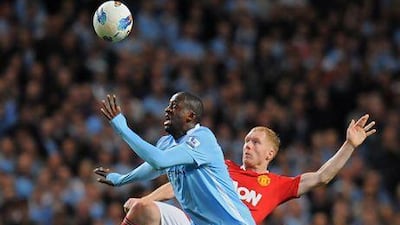 Yaya Toure, front, and Paul Scholes tussle for the ball during the corresponding Premier League fixture at Etihad Stadium last season. Andrew Yates / AFP