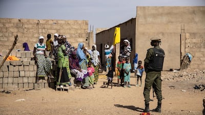 A Burkina Faso soldier patrols at a camp sheltering Malians who have fled fighting. AFP