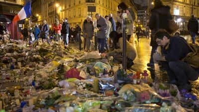The tricolore flag flies on November 20 as people commemorate the victims of the ISIL-claimed attacks in the French capital. Peter Dejong/AP Photo