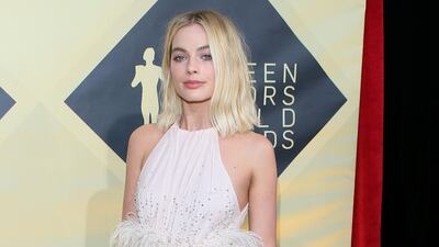 Margot Robbie opted for Miu Miu with a dash of feather-driven whimsy. Jean-Baptiste Lacroix / AFP