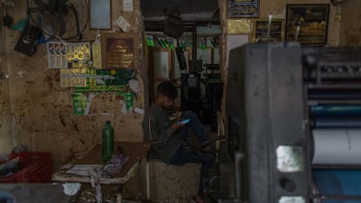 A man uses his mobile phone to work.