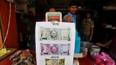 A notice is pasted at a shop stating the refusal of the acceptance of the old 500 and 1,000 Indian rupee banknotes and acceptance of the new 500 and 2,000 Indian rupee banknotes in Allahabad, India. Jitendra Prakash / Reuters