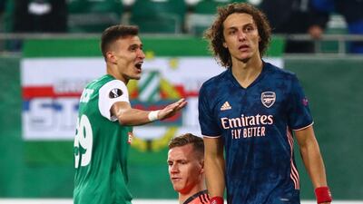 Arsenal's Bernd Leno and David Luiz look dejected after Rapid's goal. Reuters