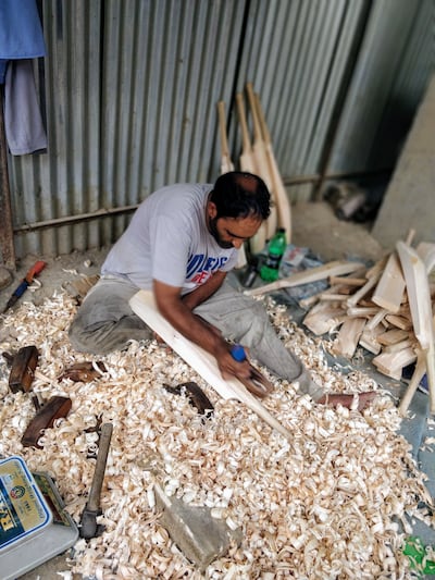 A worker engaged in shearing the correct amount of wood and shaping the bat. Photo: Kalpana Sunder