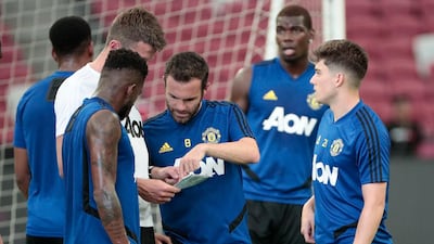 Manchester United midfielder Juan Mata, third left, hopes teammate Paul Pogba, back right, will extend his stay with the club. EPA
