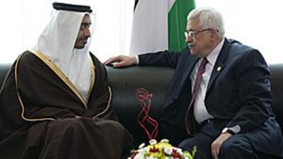 Abdullah bin Zayed, left, the foreign minister, meets with Mahmoud Abbas, the Palestinian president, at an international conference on aid for Gaza in Sharm el-Sheikh, Egypt yesterday.