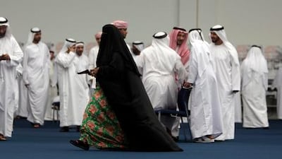 Emiratis rush to cast their votes at the Al Ain Exhibition Centre as technical problems shut down voting for two hours.