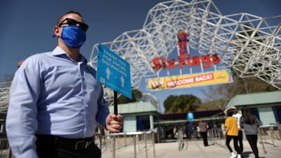 People enter Six Flags Magic Mountain amusement park on the first day of opening, as the coronavirus disease (COVID-19) continues, in Valencia, California, U.S. REUTERS
