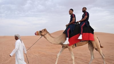 Pierre-Emerick Aubameyang and Alexandre Lacazette trek through the desert a camel during Arsenal's winter break in Dubai on Monday, February 10. Arsenal FC via Getty