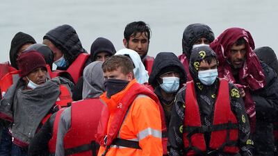 A group of people thought to be migrants are taken to Dover, Kent, onboard a Border Force vessel, following a small boat incident in the Channel. Picture date: Monday May 23, 2022.