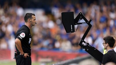 Referee Andrew Madley consults the pitch side monitor for a VAR decision during the Premier League match at Stamford Bridge, London. PA