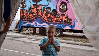 A child looks on at the Kara Tepe migrant camp, where mainly migrant families are hosted on the Greek island of Lesbos. Thousands fled days earlier when dozens of tents and shelters at the Moria camp on the island were torched, in a blaze sparked when migrants of different nationalities got into a brawl. Some migrants were shifted to the island’s second camp of Kara Tepe and some spent the night in churches, said Efi Latsoudi, a human-rights activist who was decorated for her work on Lesbos by the UN refugee agency earlier this month. AFP