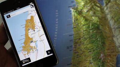 A photo taken on May 5, 2014 shows a smartphone placed on an Israeli map in Jerusalem, displaying the new Israeli NGO app called "Inakba" that allows users to find the remains of Palestinian villages that now lie inside Israel. Thomas Coex / AFP Photo