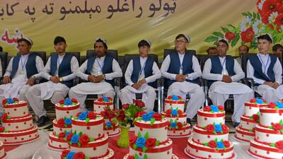Grooms wait for the start of a mass marriage ceremony in Kabul, June 13, 2022. Dozens of Afghan women in thick green shawls were married off in an austere ceremony in Kabul attended by hundreds of guests and gun-toting Taliban fighters. AFP