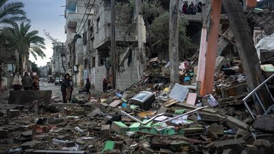 Palestinians look at the destruction after an Israeli strike in Rafah, southern Gaza Strip. AP