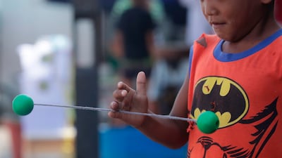Lato-lato, which is called clackers in the US, has gained popularity in South-east Asia in recent months. EPA