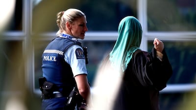A policewoman walks with a Muslim woman into the community centre on March 17, 2019 in Christchurch, New Zealand. Getty
