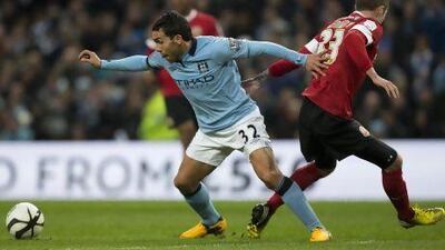 A few days after he was arrested last week, Carlos Tevez netted a hat-trick for Manchester City and will be back on the pitch Saturday against Everton. Jon Super / AP
