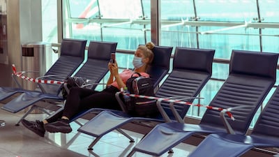A passenger waits before boarding at Dubai International Airport on April 27, 2020. Reuters