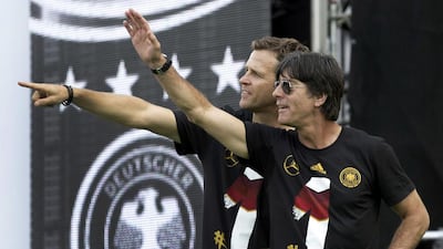 Germany's head coach Joachim Loew, right, and team manager Oliver Bierhoff applaud fans. Axel Schmidt / Reuters