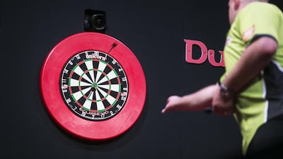 Darts players may not think much about the science behind their accuracy, but they apply it in tournaments. Mona Al Marzooqi / The National
