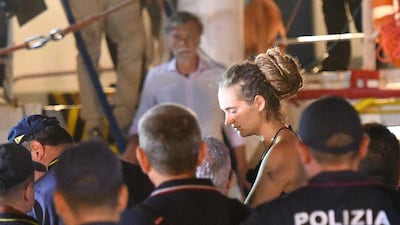 Carola Rackete, the 31-year-old Sea-Watch 3 captain, is escorted off the ship by Italian police. REUTERS