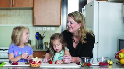 Stacie Overton Johnson with her daughters, Calla, 3, centre, and Nola, 6, left. Mona Al Marzooqi / The National