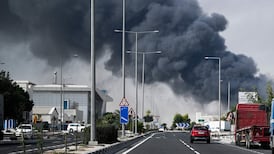 Motorists in Doha drive past a pall of smoke rising from what was reported to have been an Iranian strike on an industrial district of the Qatari capital. Tehran says its actions were in pursuit of US military installations and assets. AFP