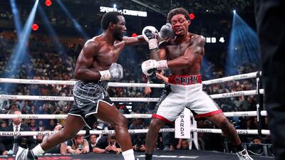 Terence Crawford, left, connects with a punch to Errol Spence Jr. AP