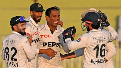 Pakistan's Noman Ali celebrates with teammates after taking the wicket of England's Zak Crawley. AFP