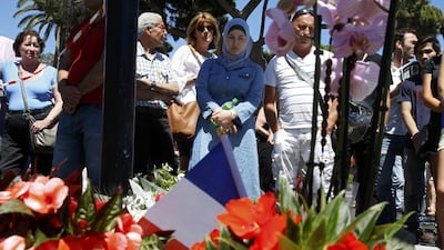 People pay tribute on July 15, 2016, near the scene where a day earlier lorry ran into a crowd at high speed. Pascal Rossignol / Reuters