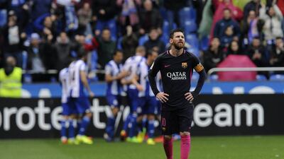 Barcelona’s Lionel Messi reacts as Deportivo players celebrate. Paulo Duarte / AP Photo