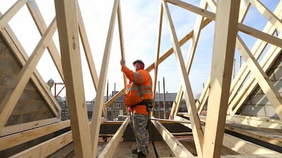 Construction in Britain is firmly back on a growth track as output in December was 2 per cent higher than it was a month earlier. Above, a builder assembles wooden roofing joists on a new home in Bedford. Chris Ratcliffe / Bloomberg News