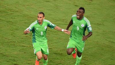 Peter Odemwingie, left, and Emmanuel Emenike, right, celebrate after Odemwingie's goal in Nigeria's 1-0 win over Bosnia on Saturday at the 2014 World Cup in Cuiaba, Brazil. Luis Acosta / AFP