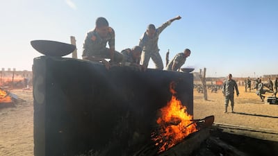 Egyptian police cadets jump over an obstacle.