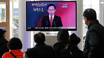 Commuters at a Seoul train station watch the South Korean president, Lee Myung-bak, deliver a new year's speech on television where he said the peninsula is at a crucial turning point.