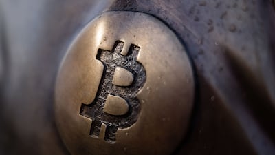 A Bitcoin logo on the sculpture representing Satoshi Nakamoto, the pseudonymous creator of Bitcoin, in the grounds of Graphisoft Park in Budapest, Hungary, last Friday. Bloomberg
