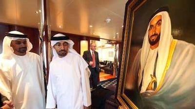 Khalifa al Kindi and Tariq al Katheeri admire a portrait of Sheikh Zayed, one of the 14 lots up for auction for Ethiopiaid yesterday.