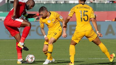Palestine's Abdellatif Bahdari, left, fights for the ball with Australia's Jamie Maclaren, centre, and Chris Iknonomidis. AFP