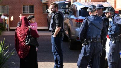Police direct locals around their search scene. William West.