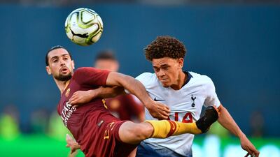 Tottenham's Luke Amos vies for the ball with Roma's Javier Pastore. AFP