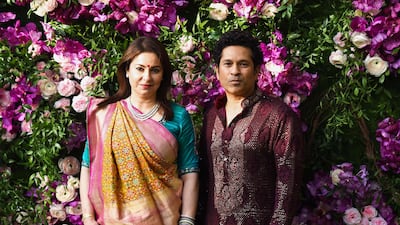 Former Indian cricketer Sachin Tendulkar (R) poses for photographs with his wife and pediatrician Anjali Tendulkar. Photo: AFP