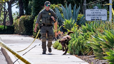 Police patrol the church grounds. AP