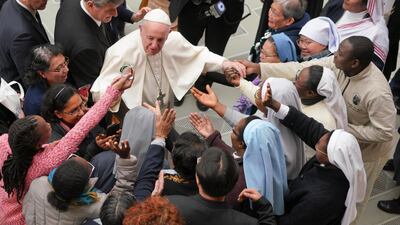Pope Francis is greeted by a group of nuns during the weekly general audience at the Vatican. Andrew Medichini / AP