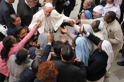 Pope Francis is greeted by a group of nuns during the weekly general audience at the Vatican. Andrew Medichini / AP
