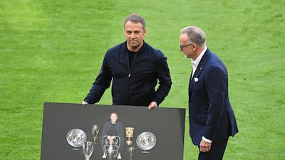 Hansi Flick is presented with a poster of his achievements at Bayern Munich by chief executive Karl-Heinz Rummenigge before his final game in charge of the Bavarian club in May. AFP